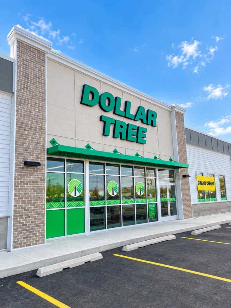 Exterior of the new Dollar Tree in Howard featuring branded storefront signage, large glass entrance doors and windows, brick accents, and a newly paved parking area.