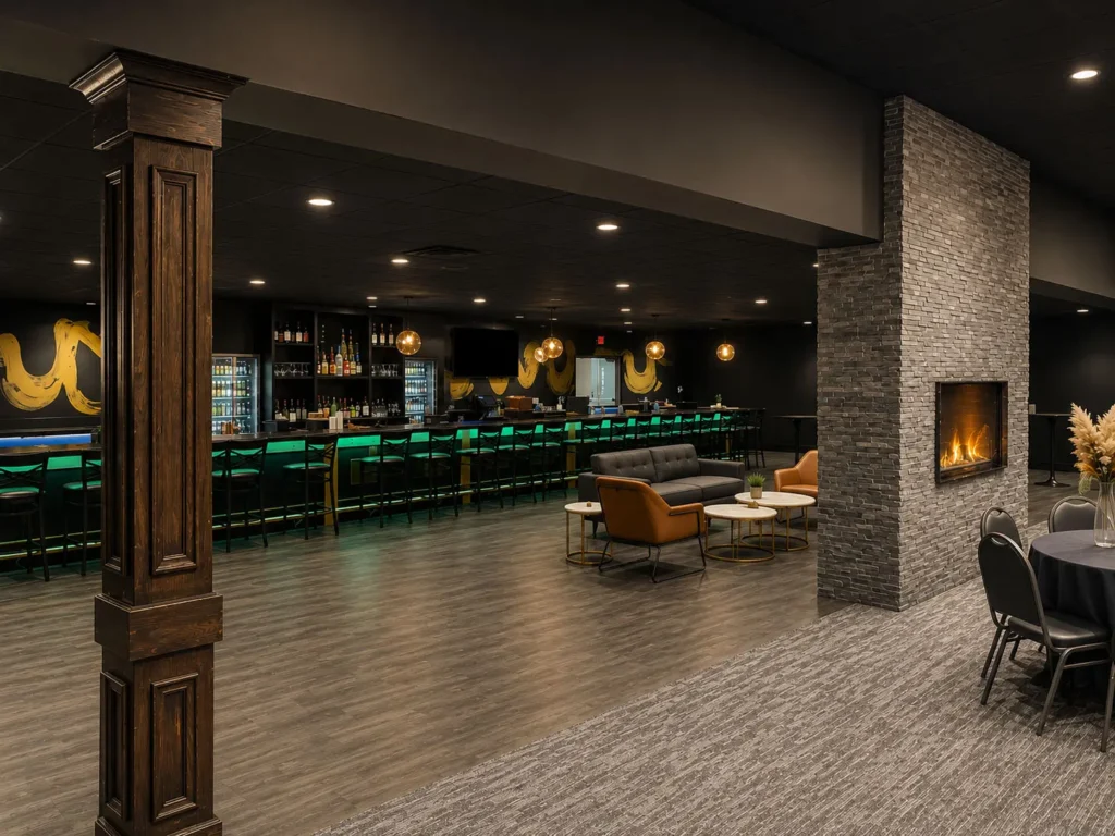 Lounge and bar area within Stadium View Sports Bar's renovated banquet facility, featuring a custom illuminated bar, fireplace, comfortable seating, and upscale finishes inspired by the spirit of Lambeau Field.