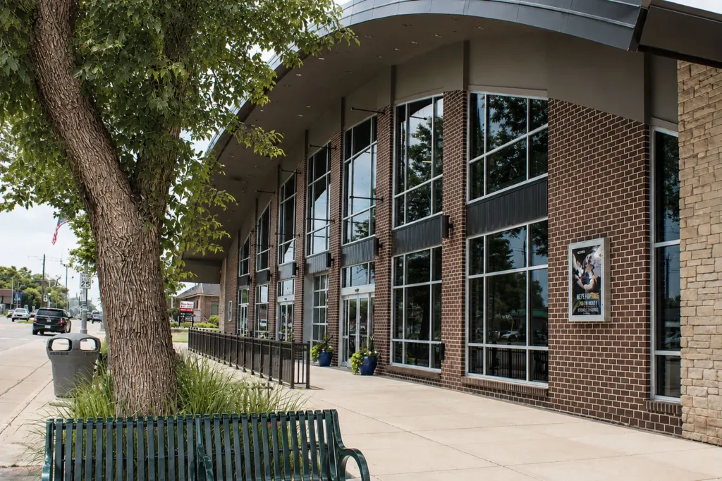 Exterior entrance of 922 Ministries The Core in Appleton featuring a modern brick and stone façade, expansive floor-to-ceiling windows, covered pedestrian walkway, and welcoming streetscape design.